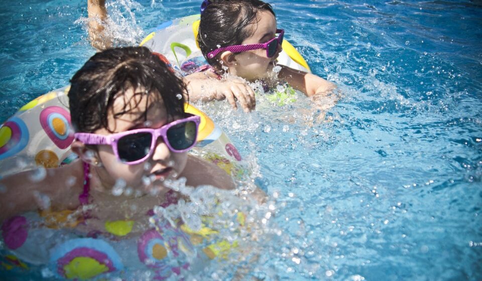 girls, swimming, splashing, sisters, little girls, floaters, swim, swimming pool, pool, summer, vacation, splashing water, childhood, children, kids, shades, sunglasses, people, water, cute, wet, young, happy, joy, nature, fun, activity, happiness